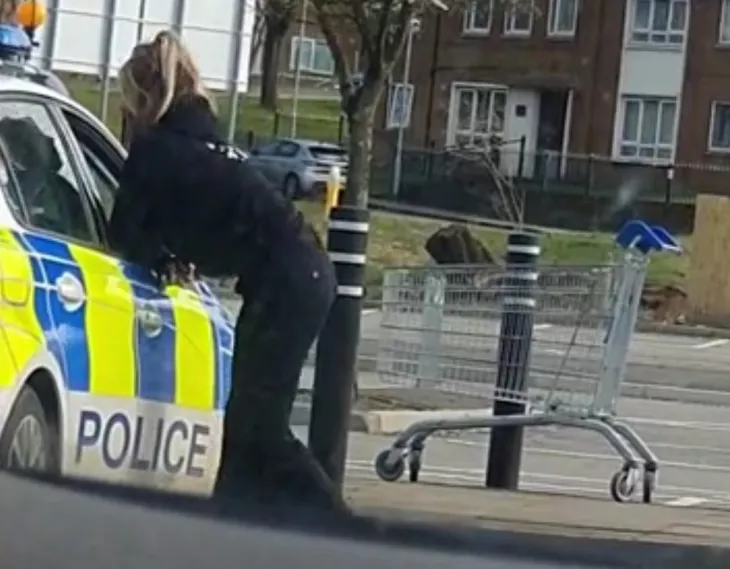 Police officers seen kissing in a parking lot